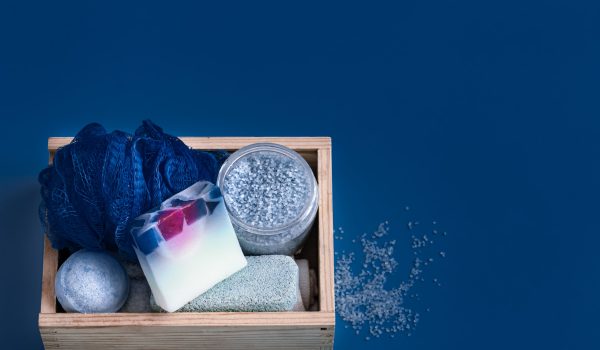 Different body care items on blue background, Spa care and hygiene concept .